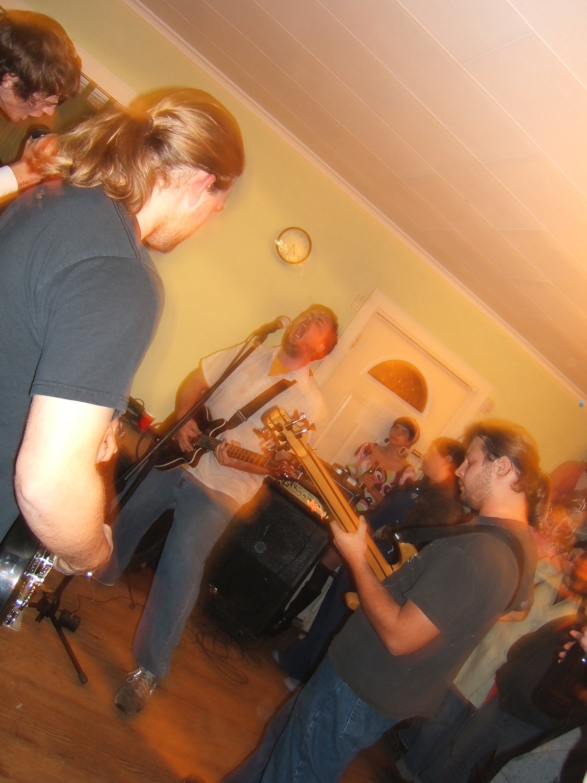 Diver playing a house show in a living room, crowd close in.